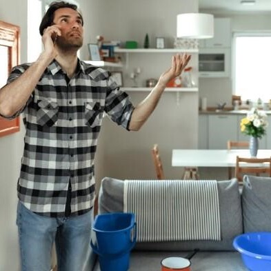 Man checking roof water leak